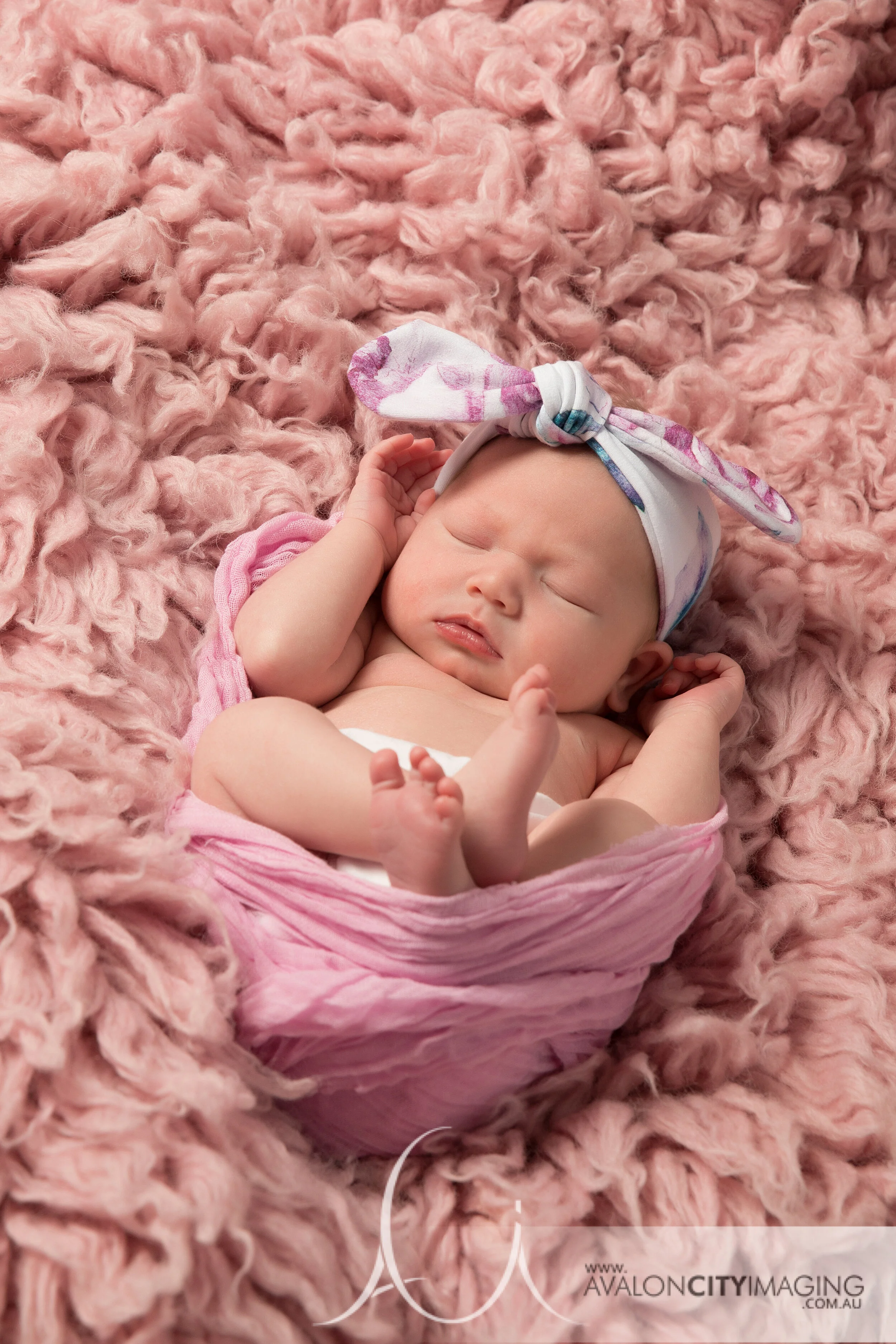 Adelaide Newborn Photography - Newborn girl wrapped on pink fur