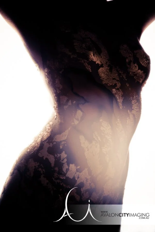 body art photography - female torso with body painting standing in dramatic studio lighting.jpg