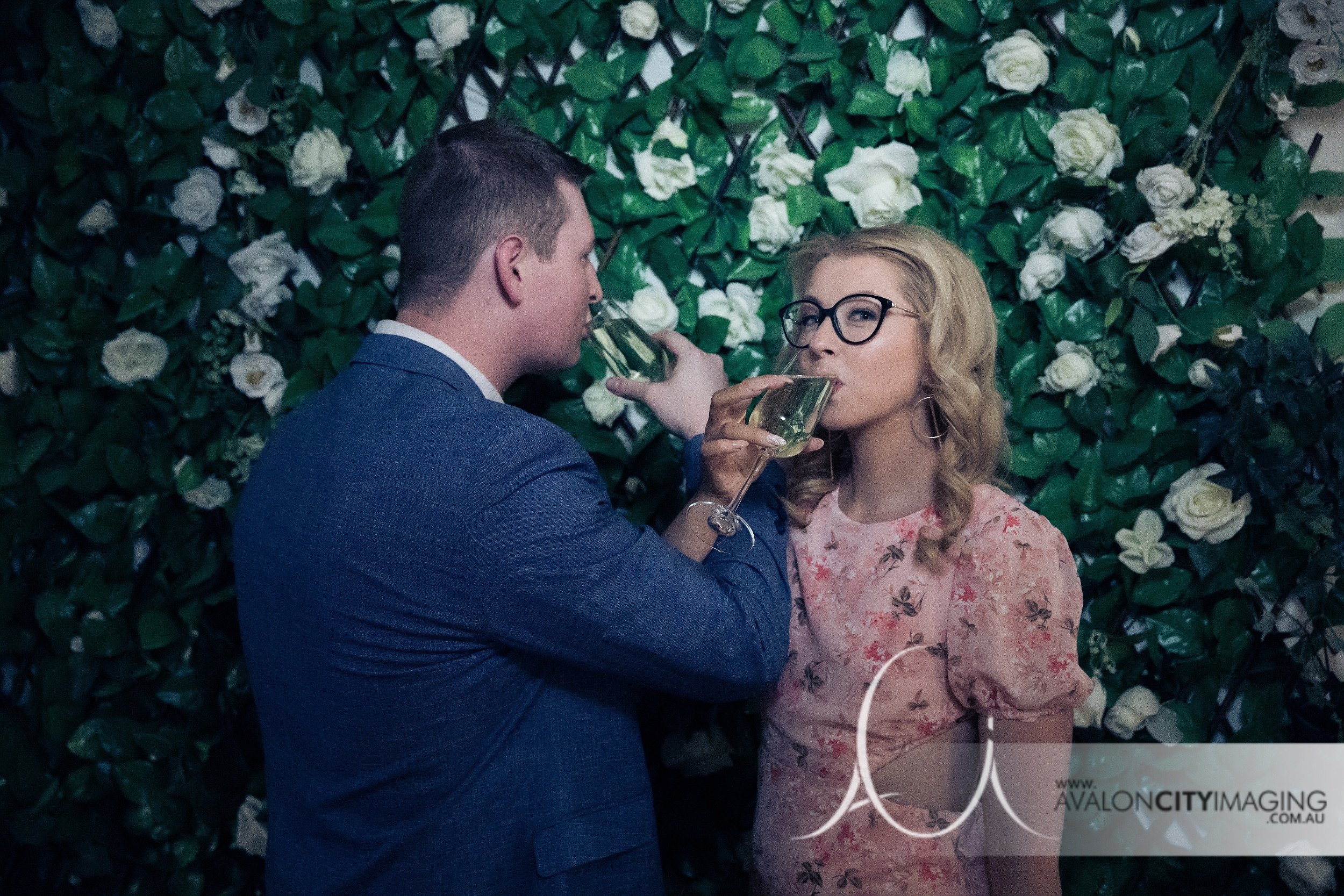 Engagement photography- couple toasting to thier engagement in a fun studio setting.jpg