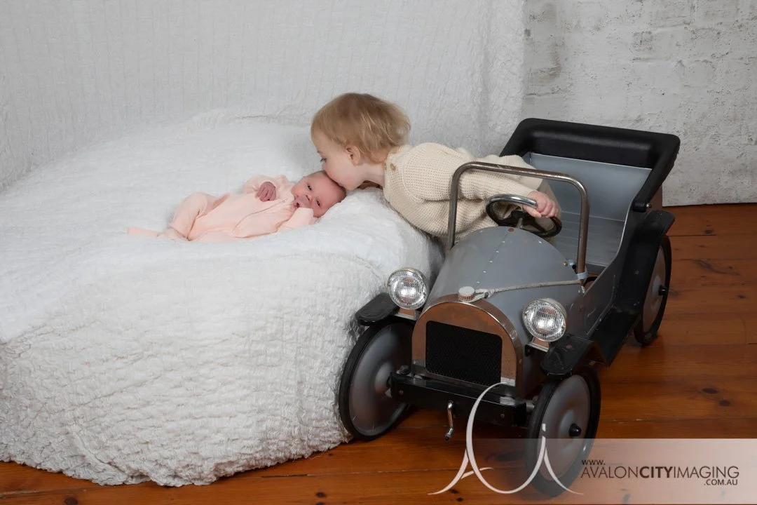 Adelaide Newborn Photography - Big sister kissing newborn baby sister