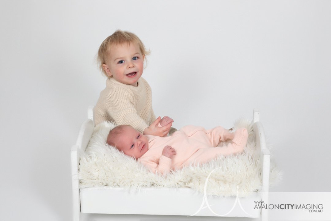 newborn photography - newborn studio photography with sibling sitting nicely clean lighting.jpg