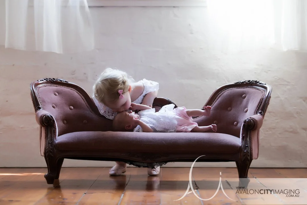 newborn photography - newborn lying beside older sibling in a gentle pose.jpg