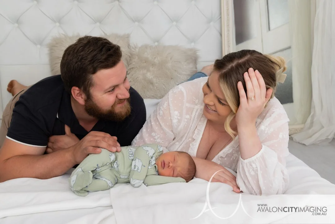 newborn photography - newborn posed with both parents creating a warm family connection.jpg