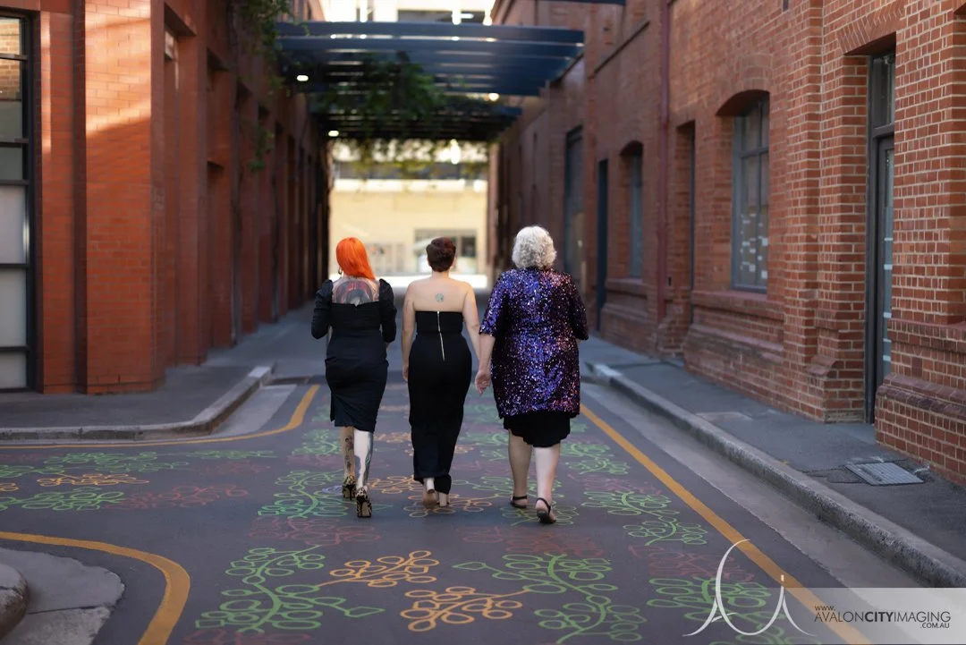 Family photography- mother and dults daughters walking elegantly down city street in eveningwear.jpg