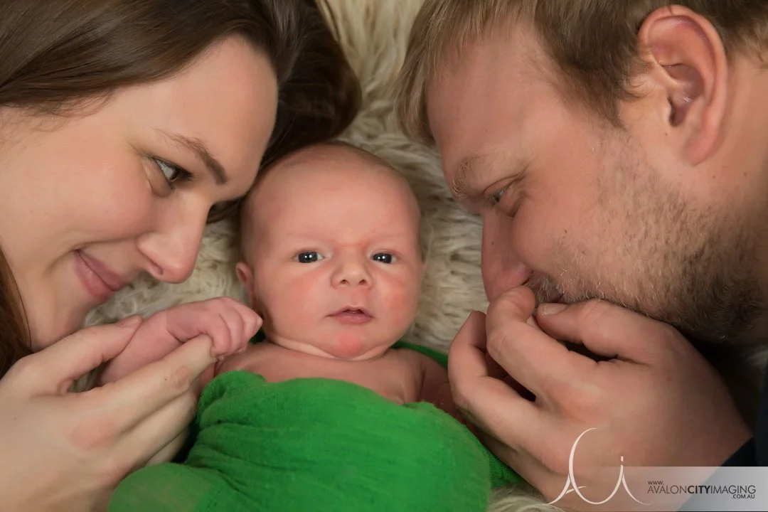 newborn photography - parents embracing newborn with calm, intimate styling.jpg