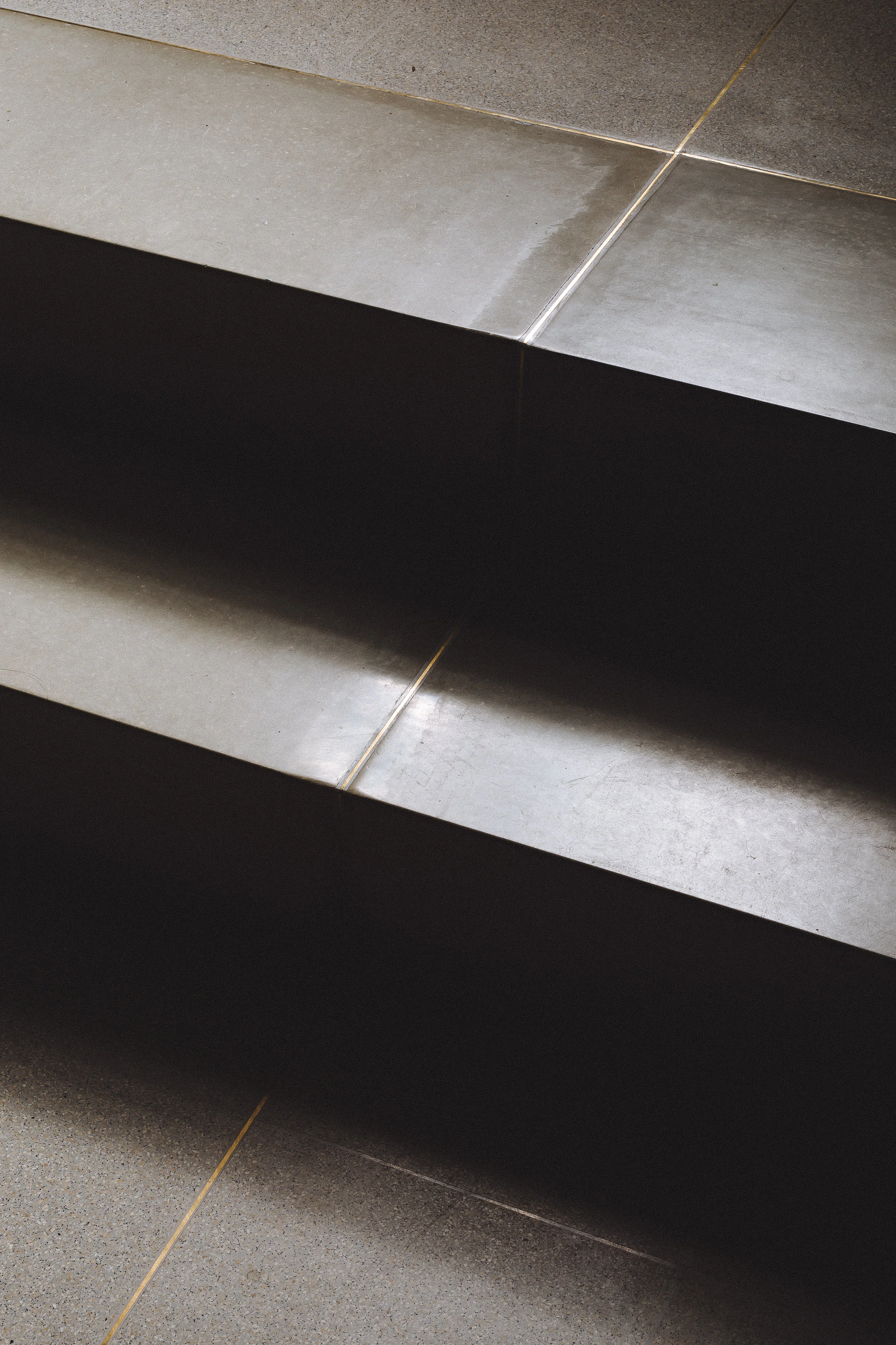 Concrete and terrazzo with brass inlay