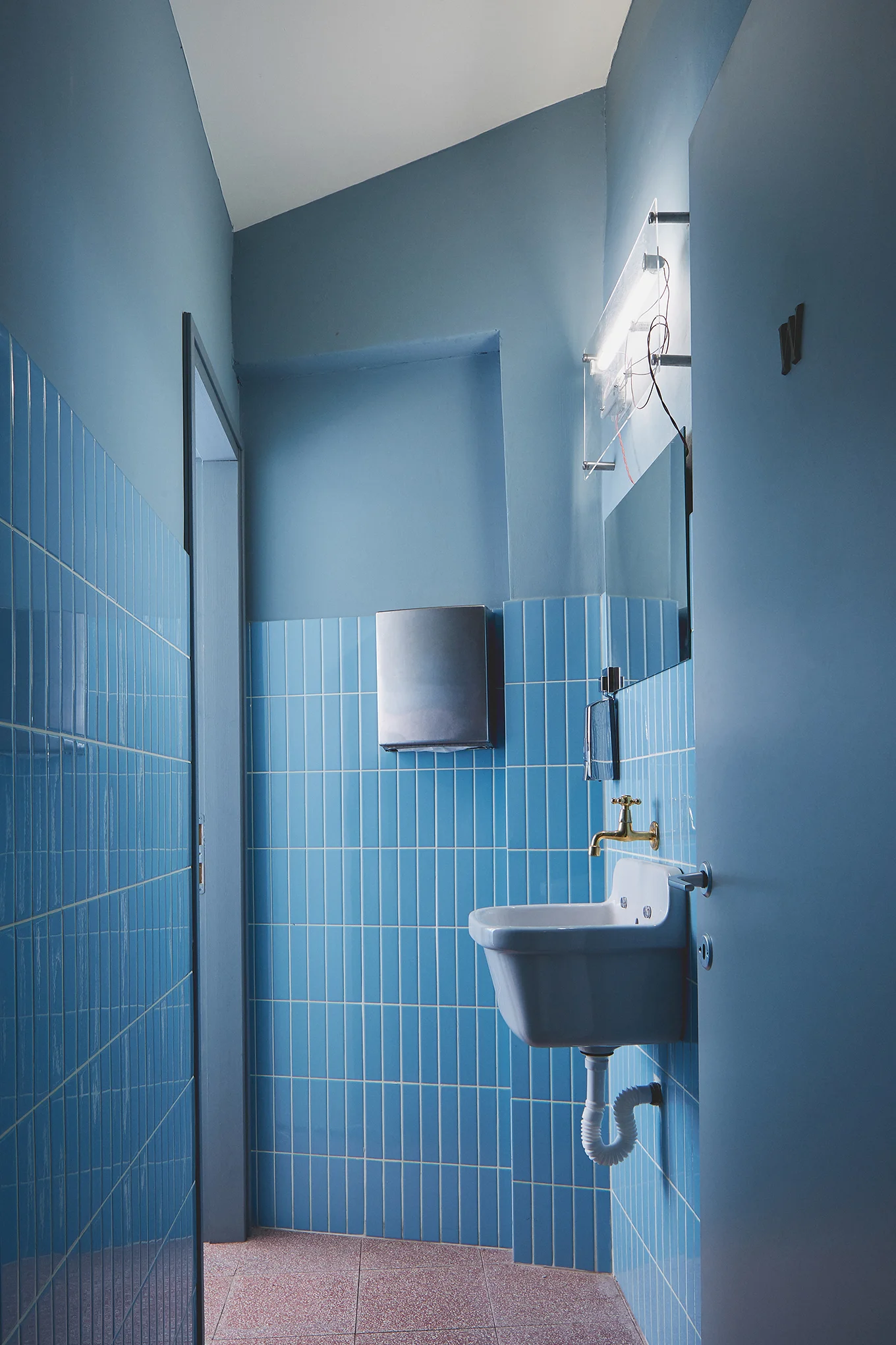 restaurants toilets with red terrazzo floor and light blue tiles