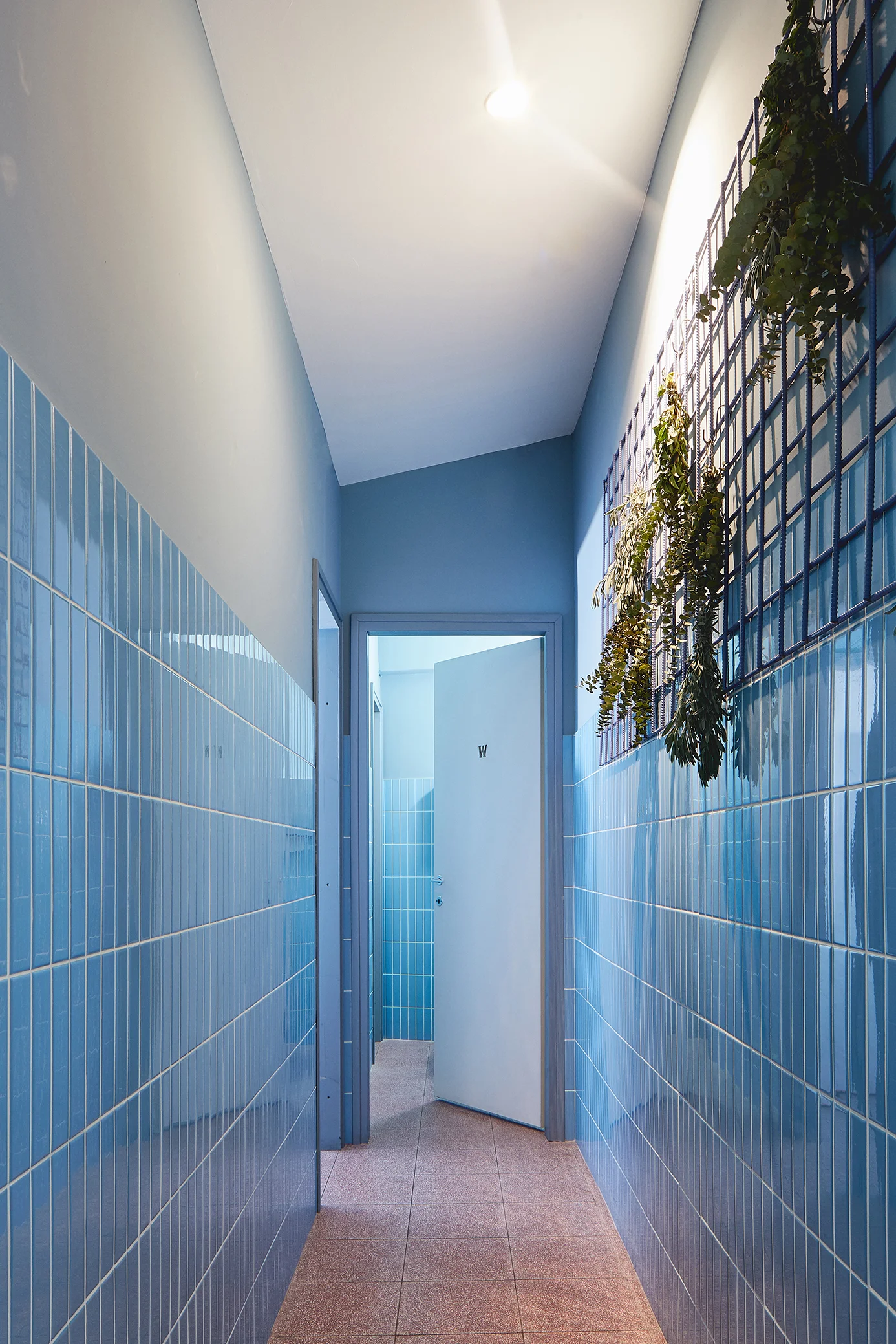 restaurants toilets with red terrazzo floor and light blue tiles