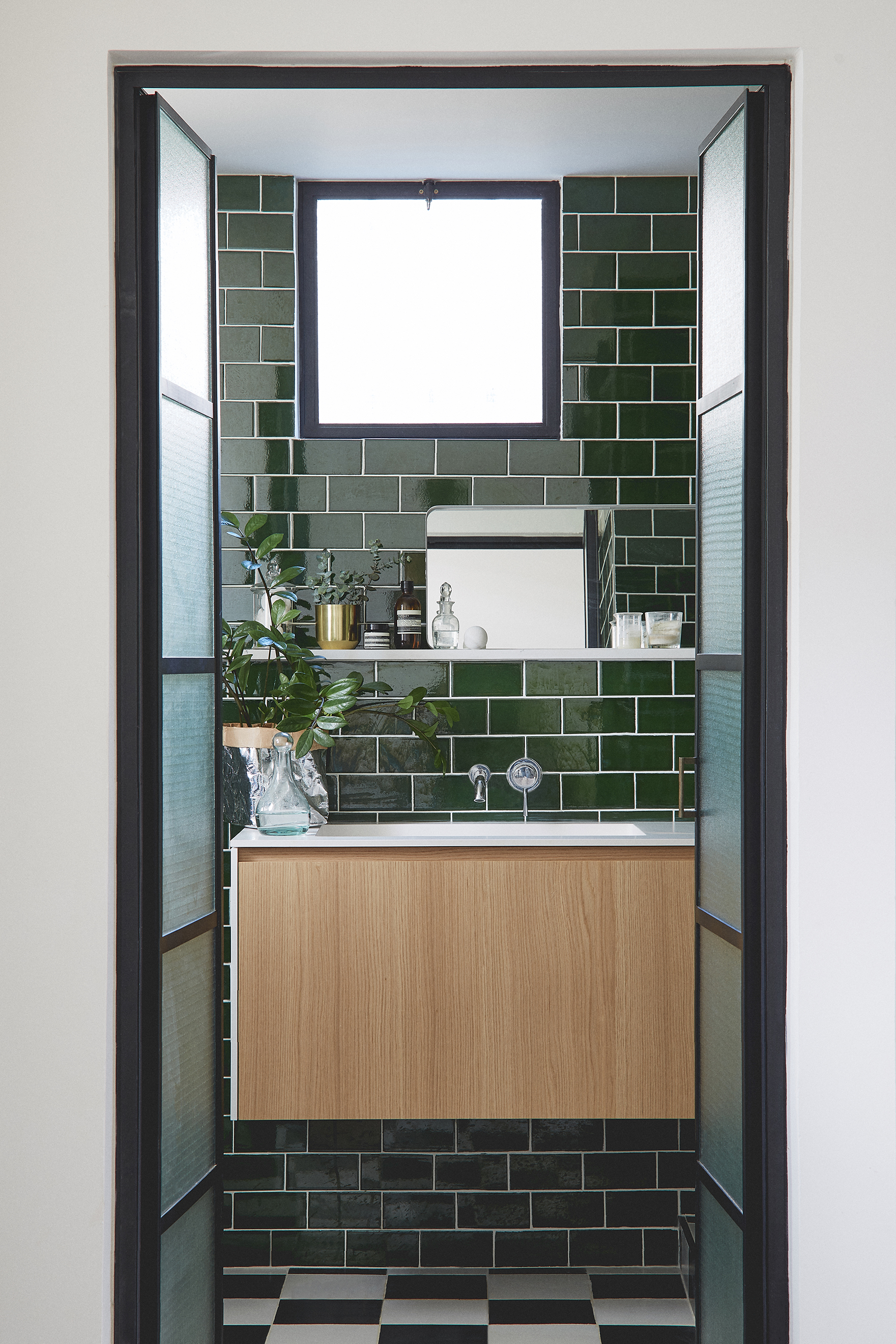 green subway tiles bathroom checkers-like floor, steel frame doors bathroom