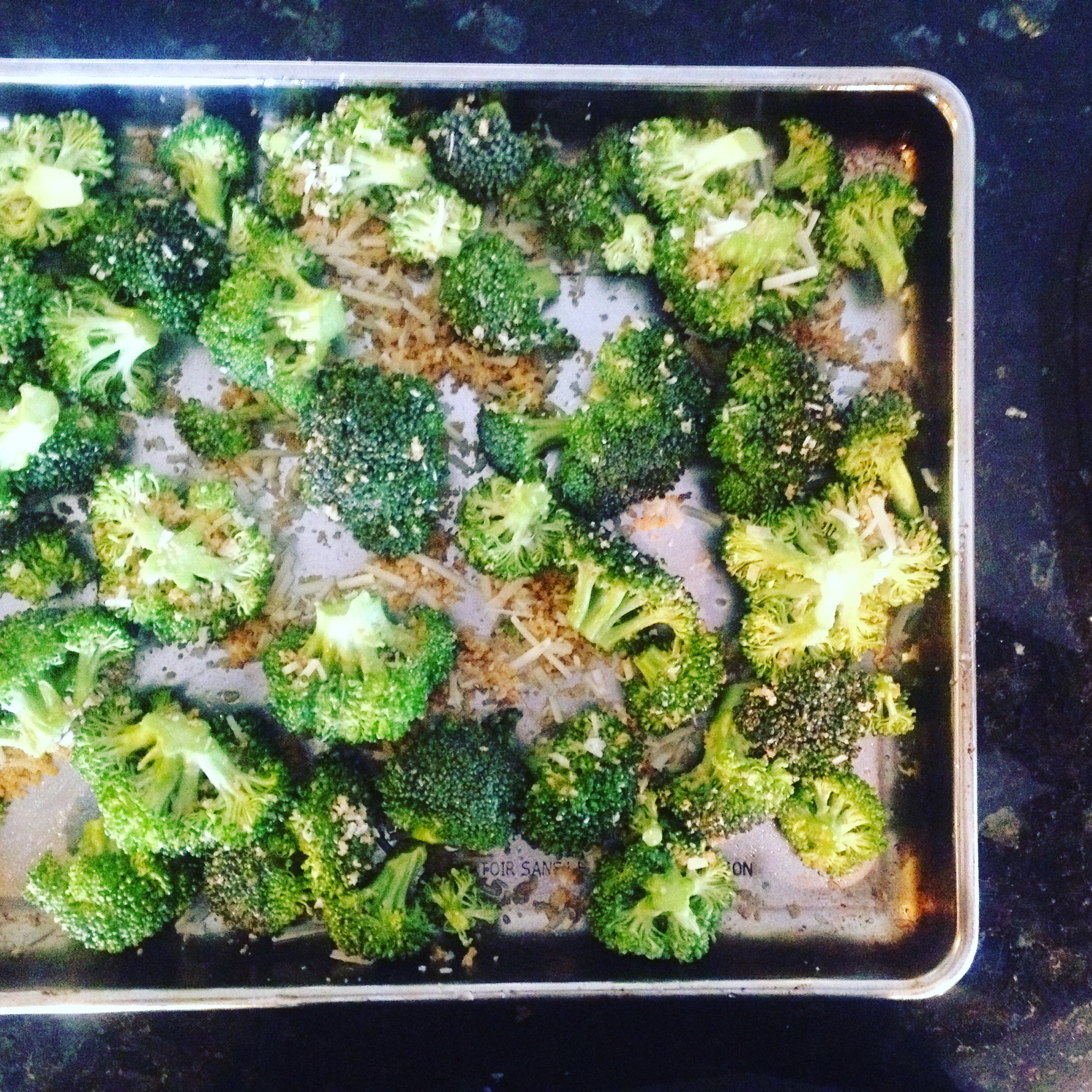Toss 4 cups broccoli florets with 1/4 cup whole wheat panko brad crumbs, 2 teaspoons garlic powder, and 1/4 cup grated Parmesan cheese. Roast for 15 - 20 minutes at 425 degrees F. 