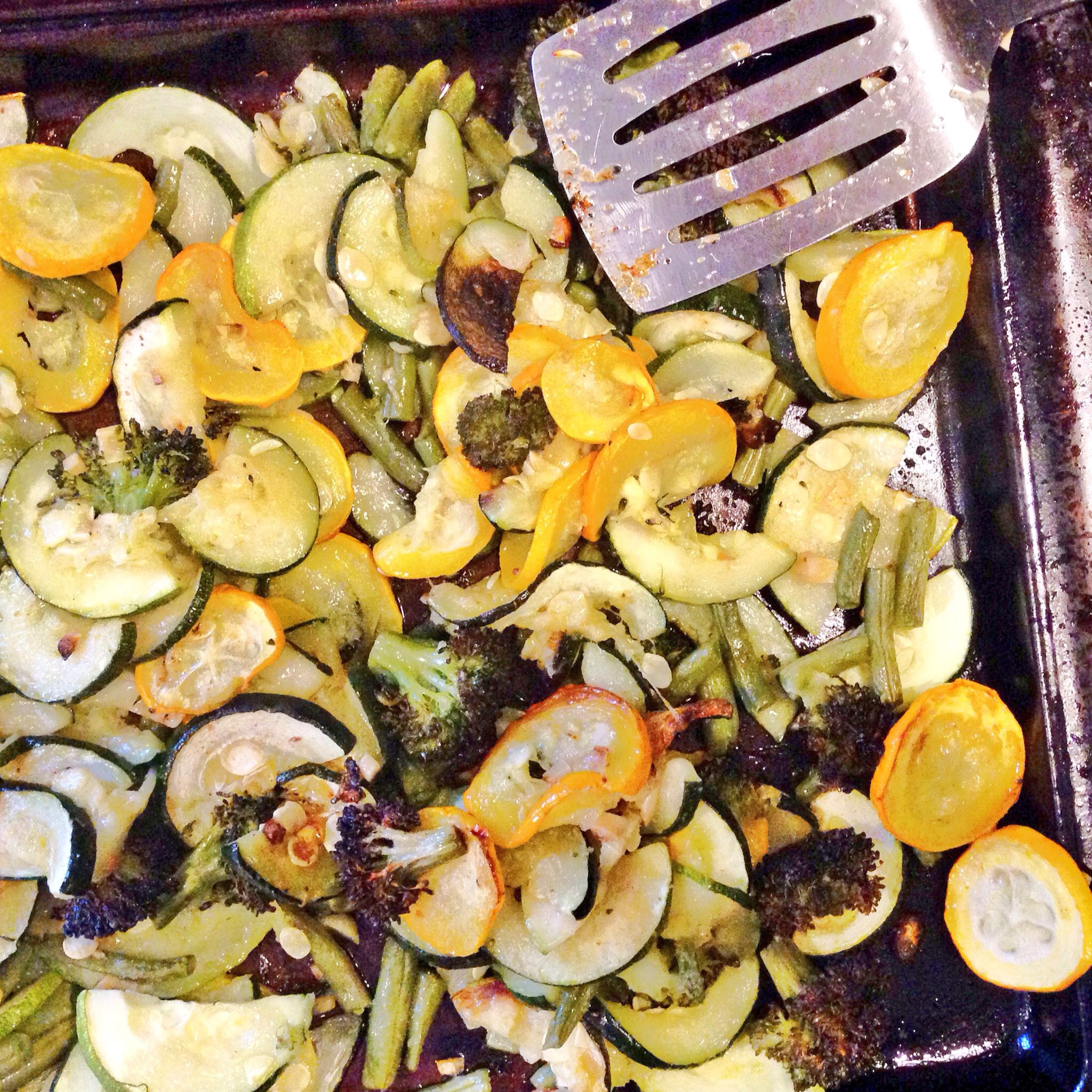Slice a zucchini, summer squash, and add 1 cup green beans, 1 cup broccoli florets, 5 cloves of garlic minced, and 1 tablespoon olive oil. Toss together and roast for 25 - 30 minutes at 425 degrees F. 