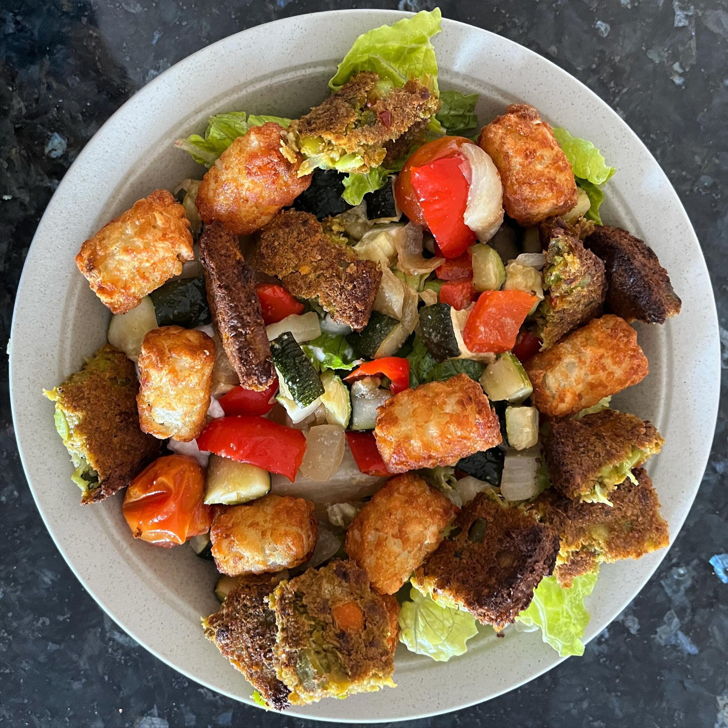 Made one of my favorite salads today - Veggie Burger &amp; Tots! 

☑️ Easy to Make
💚 Plenty of Veggies*
😃 Air-Fried Tots 
💪 Protein**

* Topped with leftover garlic roasted veggies from dinner last night! 
** Added a scoop of cottage cheese under 