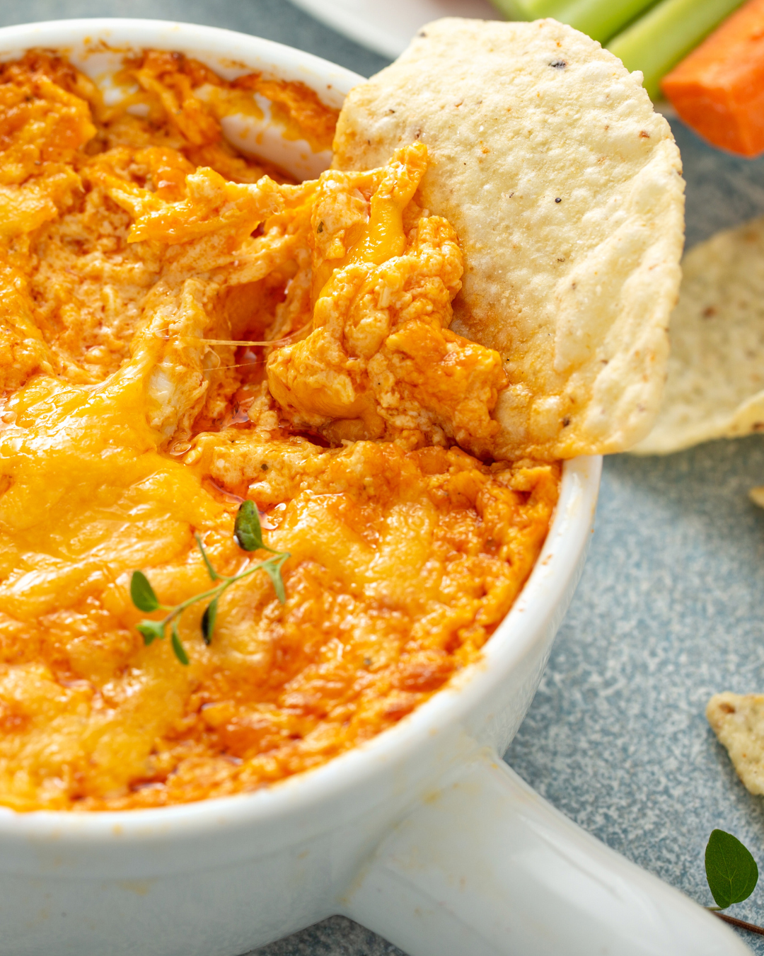 Dish of buffalo chicken wing dip with tortilla chips