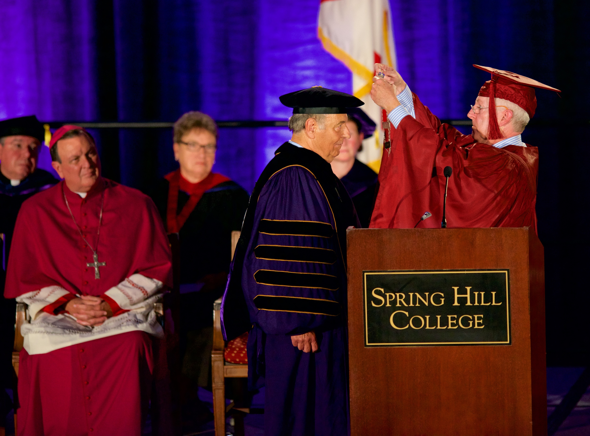 Chairman of the Spring Hill College Board Michael Coghlan presents Dr. Puto with the SHC presidential medallion. Photo by Spring Hill College.