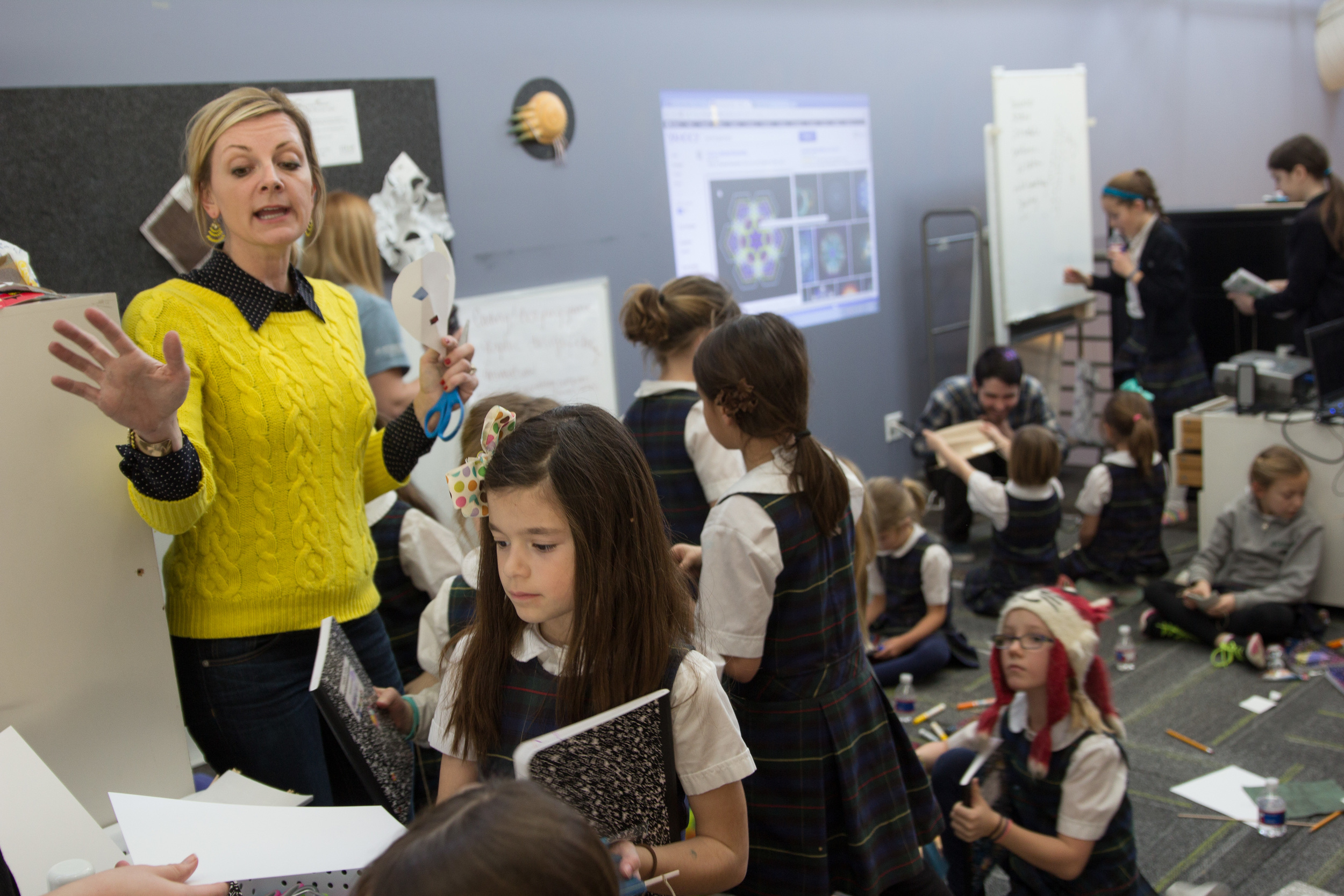 Mandi Sonnenberg, Ed.D., associate professor of education at Rockhurst University, leads an activity during the STEAM camp for girls at Gould Evans STEAM Studio in Kansas City, MO (Photo by Rockhurst University)