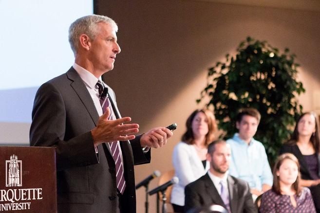 Marquette University President Michael R. Lovell addresses a capacity crowd at a Near West Side Partners community forum. (Photo by marquette University)