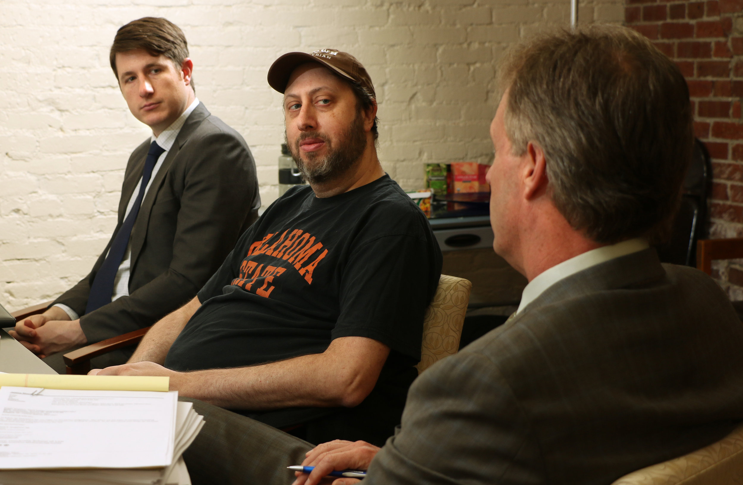 Attorneys John Varga and Jon Quittner meet with mentor Stan Perkins for guidance on running a successful low bono practice. (Photo by Seattle University)