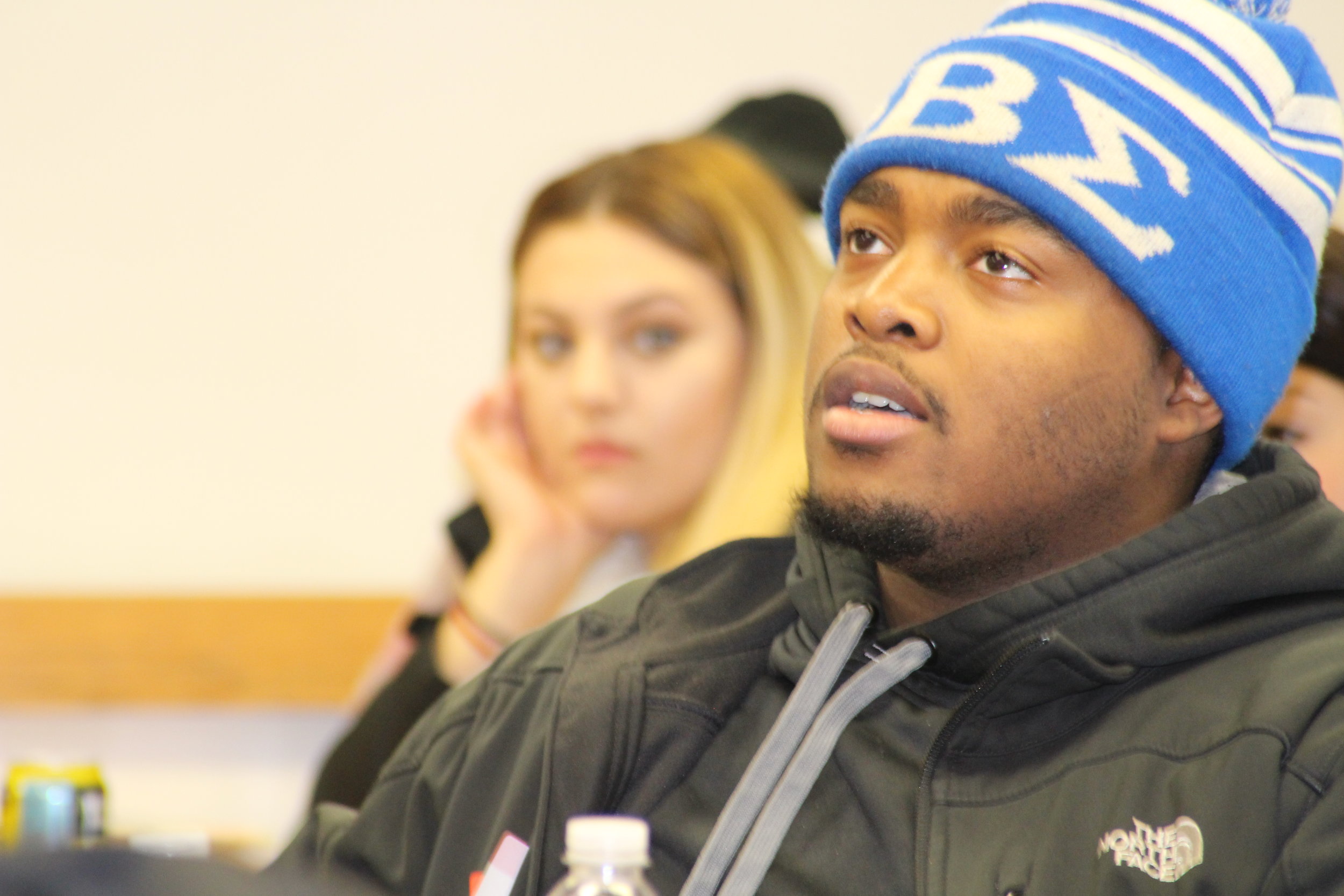 First-generation students Barbara Fama and Jamari Rowland listen to a speaker at a FirstGen Network meeting Photo by University of Detroit Mercy).