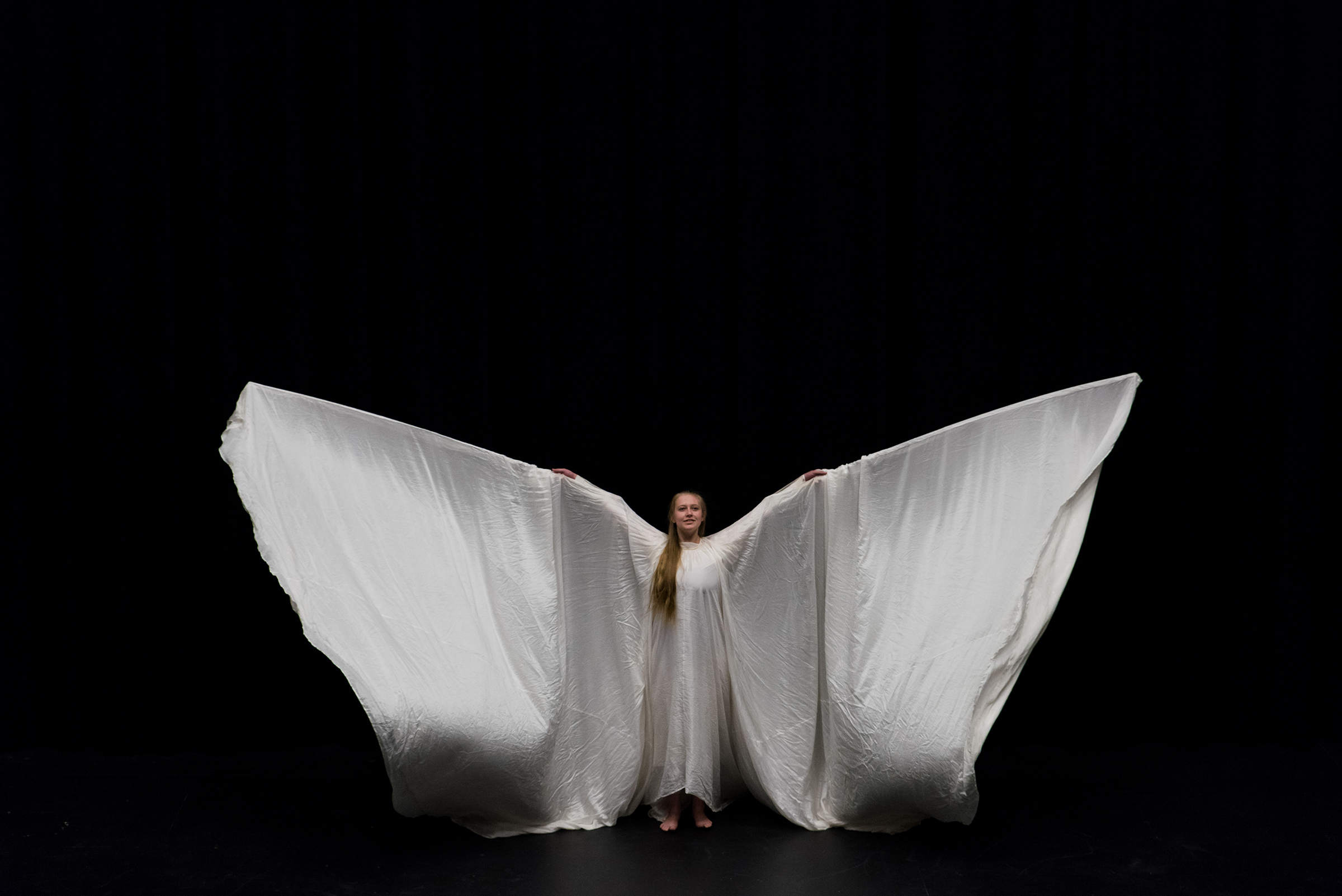 Dancer in white: Laura Miller re-created the work of famed American interdisciplinary dance artist Loïe Fuller in a preview of the Spring 2017 Dance Performance at Gonzaga (Photo by Edward Bell)