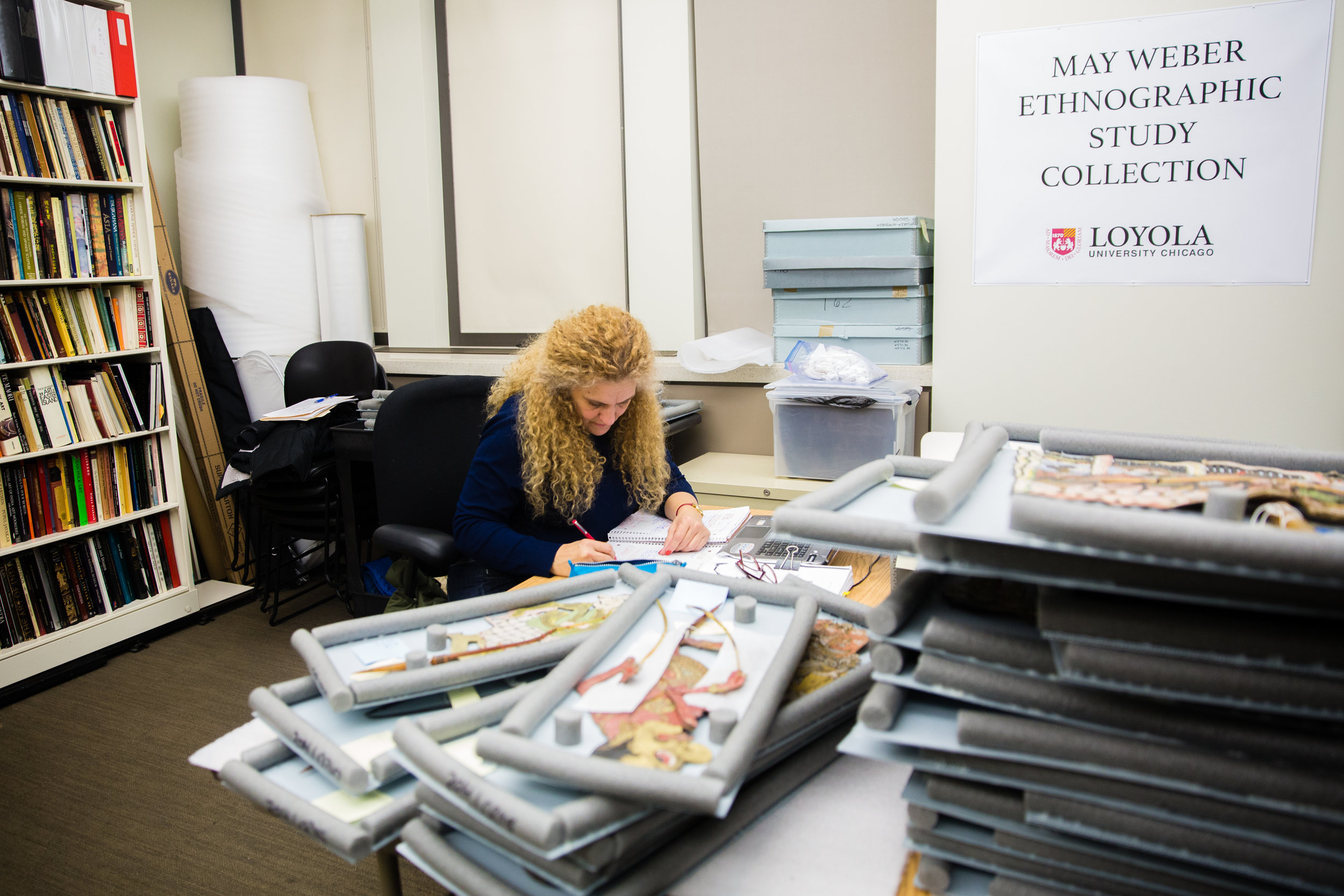 Tamara Franco, a student in Loyola’s Department of Anthropology museum studies internship course, works on the upcoming exhibition, Wayang: The Art of Indonesian Puppetry at Loyola University Museum of Art (Photo by Natalie Battaglia)