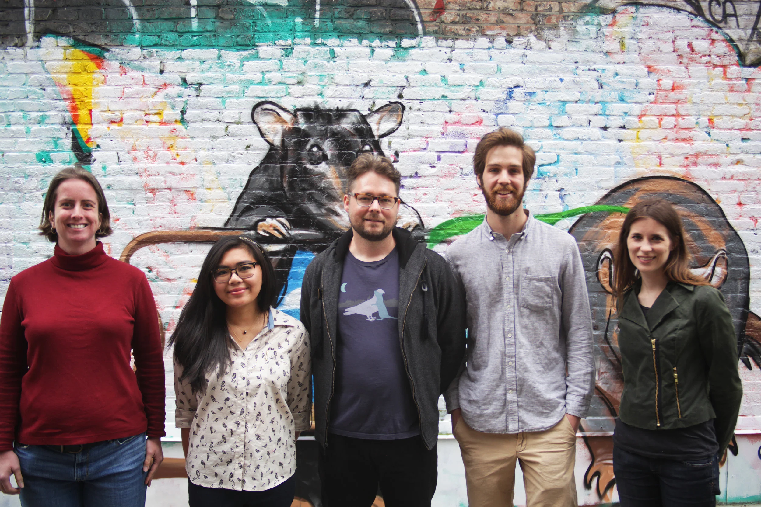 Jason Munshi-South (center), Matthew Combs (right) and members of their research team who participated in Street Art for Street Rats this summer in Manhattan. The event helped to educate New Yorkers about their most reviled rodents and paint murals in a public park space together (Photo by Fordham University)