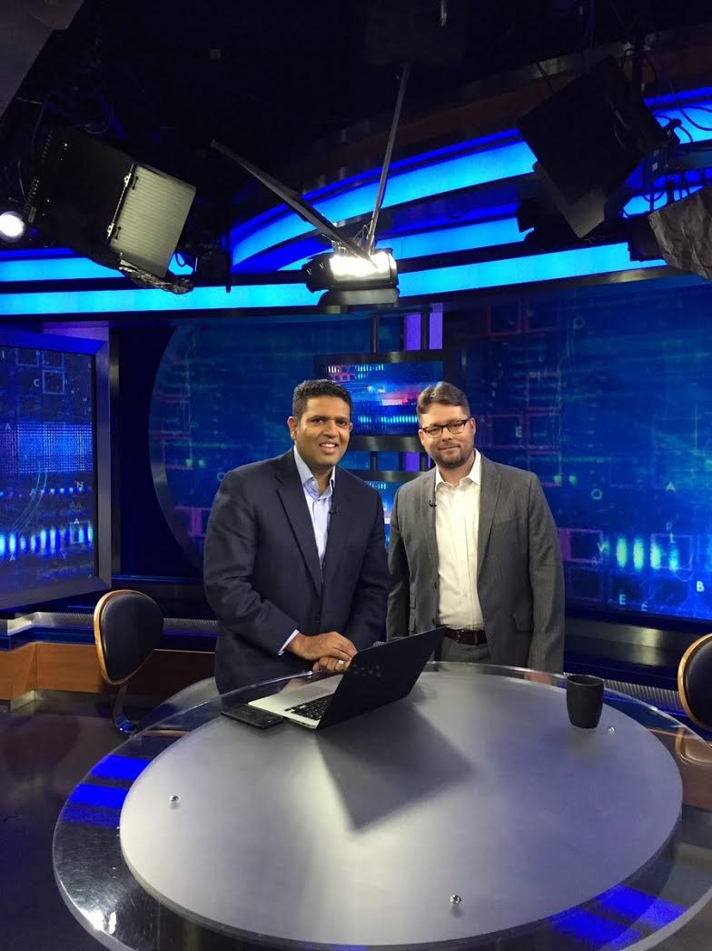 Jason Munshi-South with PBS' Hari Sreenivasan on the set of SciTech Now (Photo by Fordham University)