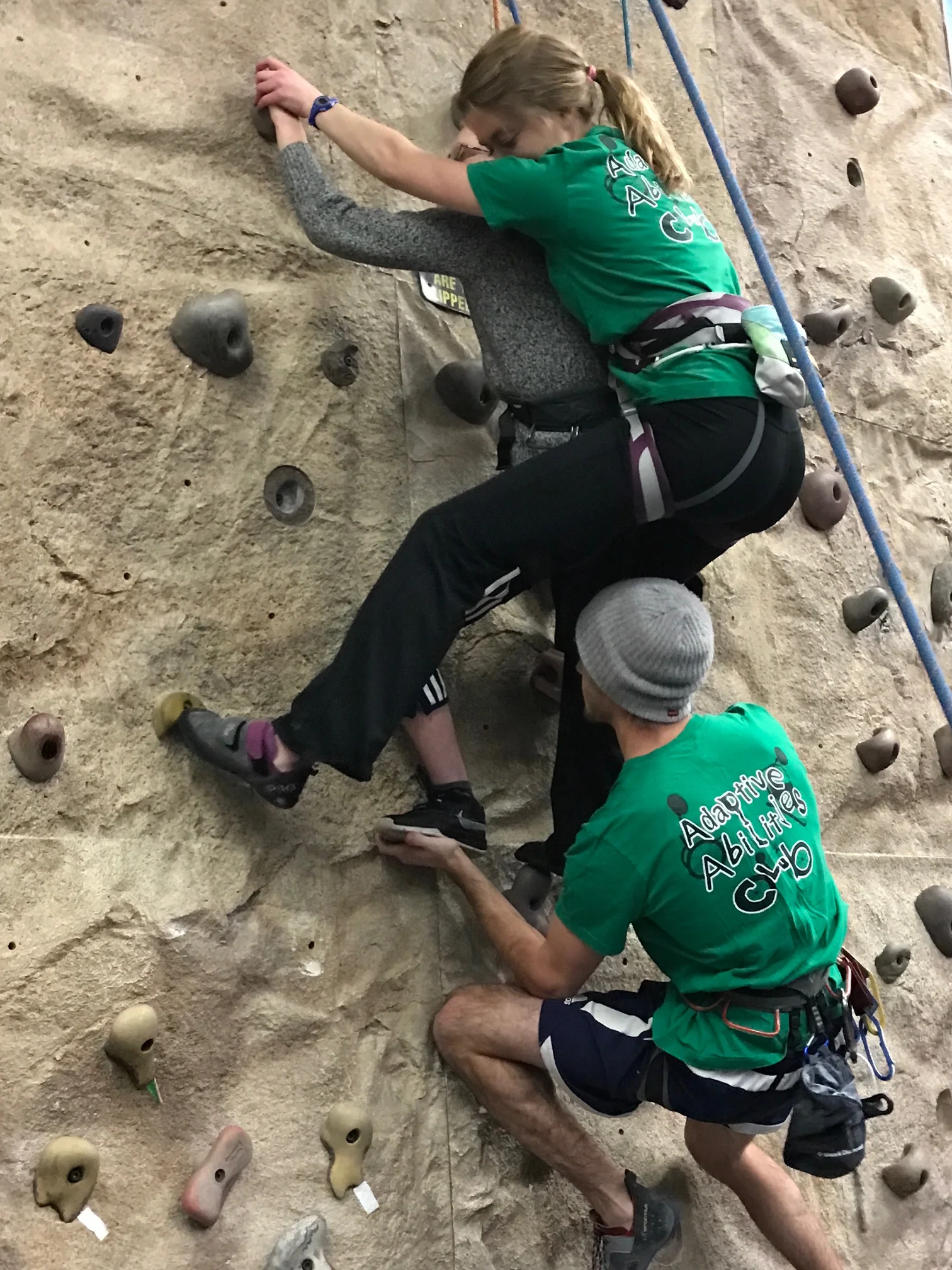 Adaptive Abilities Club members Kelly Bush and Zach Hodgson help Matthew Knowles rock climb (Photo by Marquette University)