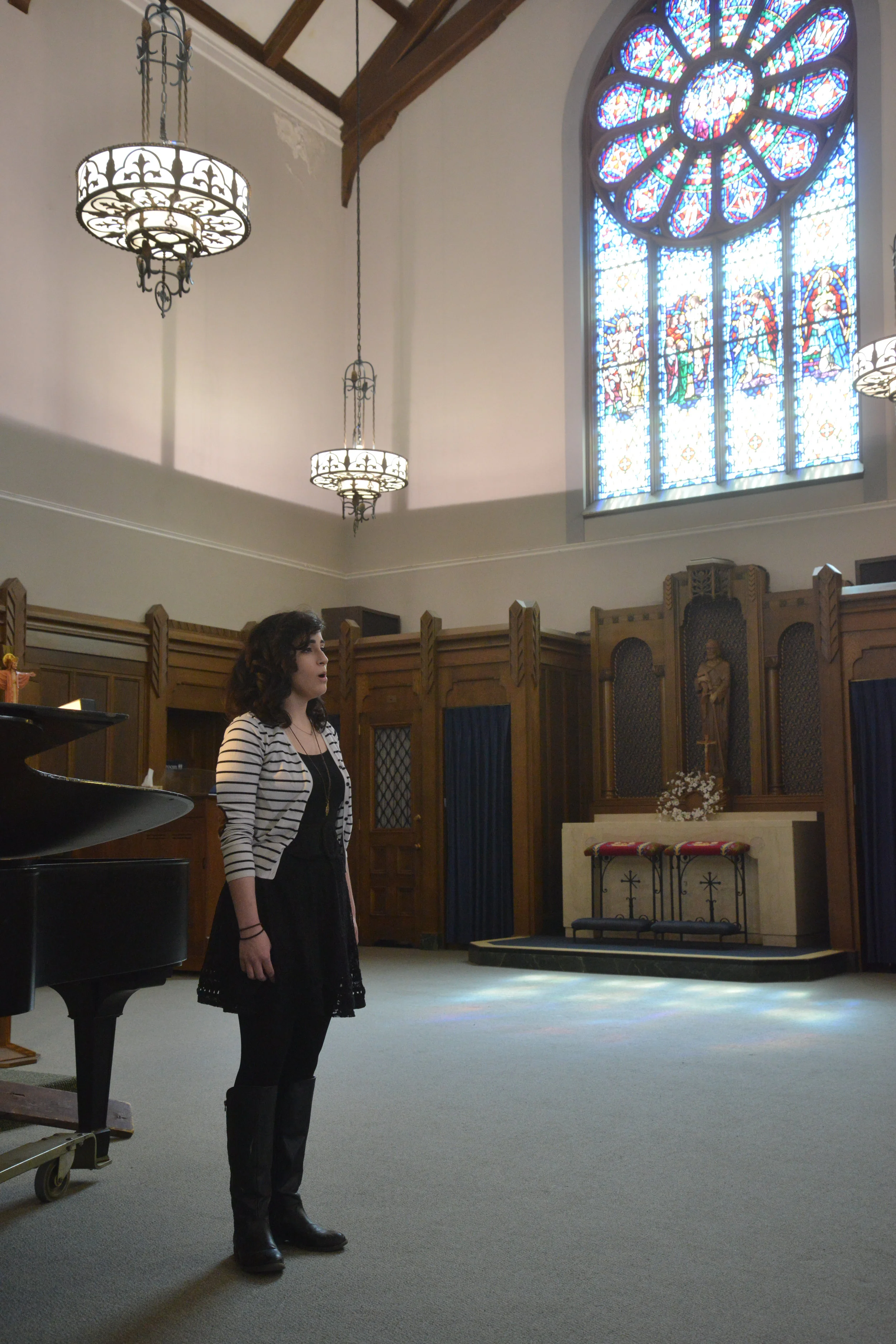 A student sings during Mass at Christ the King Chapel (photo courtesy of Canisius College)