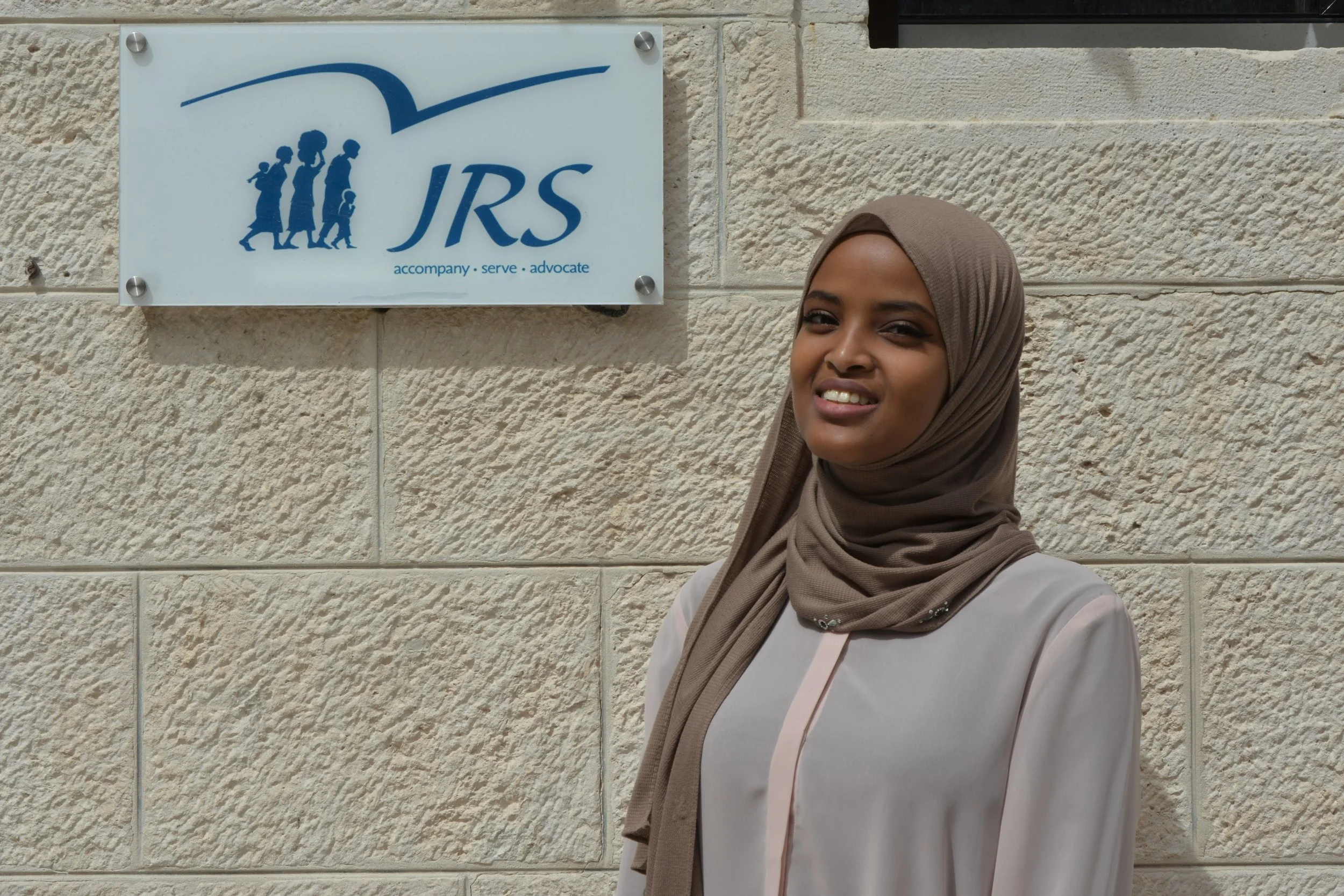 Fowzia, originally from Somalia, is a former student in a JRS camp who now volunteers as an English teacher (photo by JRS International)