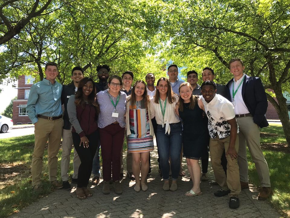 Front row (L-R): Sierra Ambrose (Loyola University New Orleans), Claire Webster (Rockhurst University), Katlyn Martin (Saint Louis University), Meredith Gillespie (Marquette University), Meredith Coolidge (College of the Holy Cross), Dayne Guy (St. John's College in Belize). Back Row (L-R): Cole Stautberg (Xavier University), Rico Gomez (Regis University), Adrian Chacho (College of the Holy Cross), Patrick Marta (Creighton University), Hamza Elhabbal (Le Moyne College), Matt Smardz (Canisius College), Ignacio Fletcher (Boston College), Alo Coleman (Loyola Marymount University), Reed Piercey (Boston College)