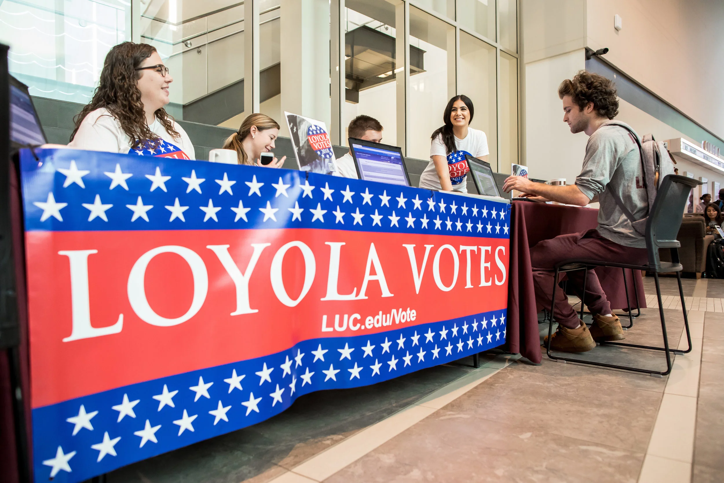 Loyola University Chicago senior Will Gaudet (right) registers to vote in the Damen Student Center on September 25 as part of a National Voter Registration Day drive. In advance of the 2018 midterm elections, Loyola helped nearly 800 students register to vote through registration events on campus. (Photo: Lukas Keapproth)