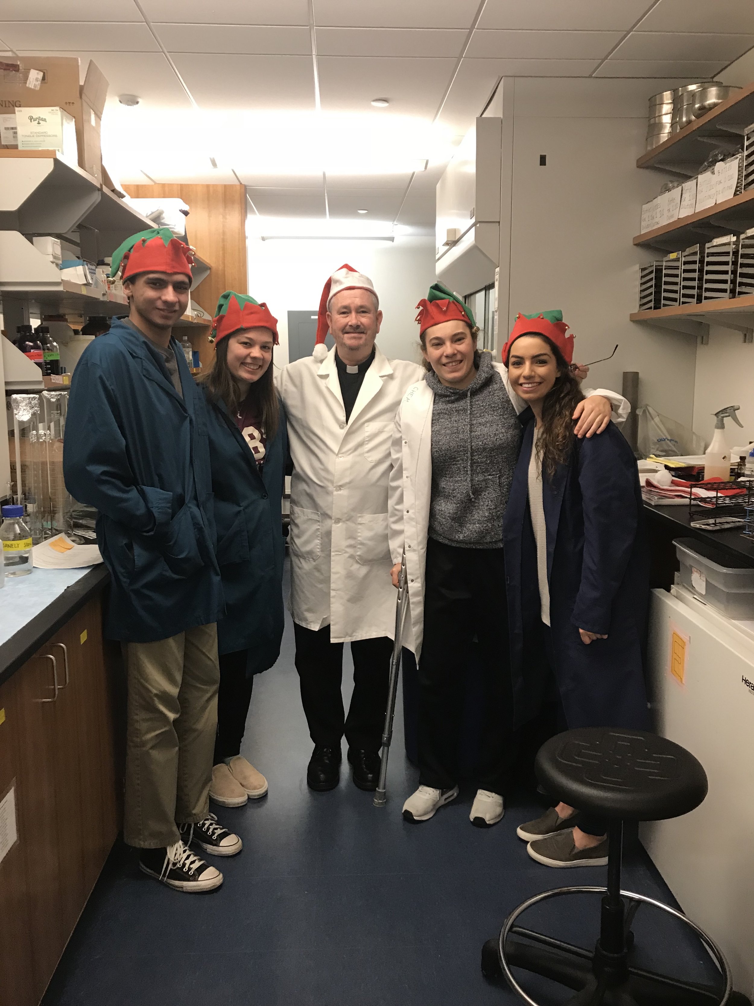 “Merry Scientists” (a.k.a. teaching assistants) help biology professor, Rev. Timothy Cadigan, S.J., in his lab at the University of Scranton this holiday season (photo by University of Scranton)
