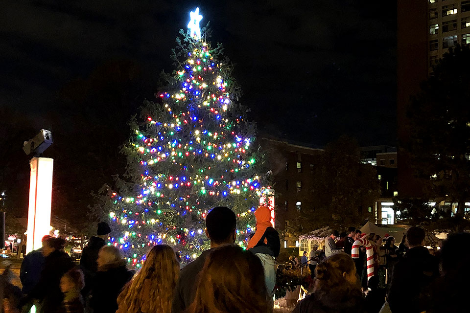 A crowd of students, faculty and staff basks in the glow of Saint Louis University's Christmas Tree during its Christmas on the Quad celebration on December 1 (photo by Amelia Flood, Saint Louis University Marketing and Communications; click here for more photos from SLU’s tree lighting ceremony )