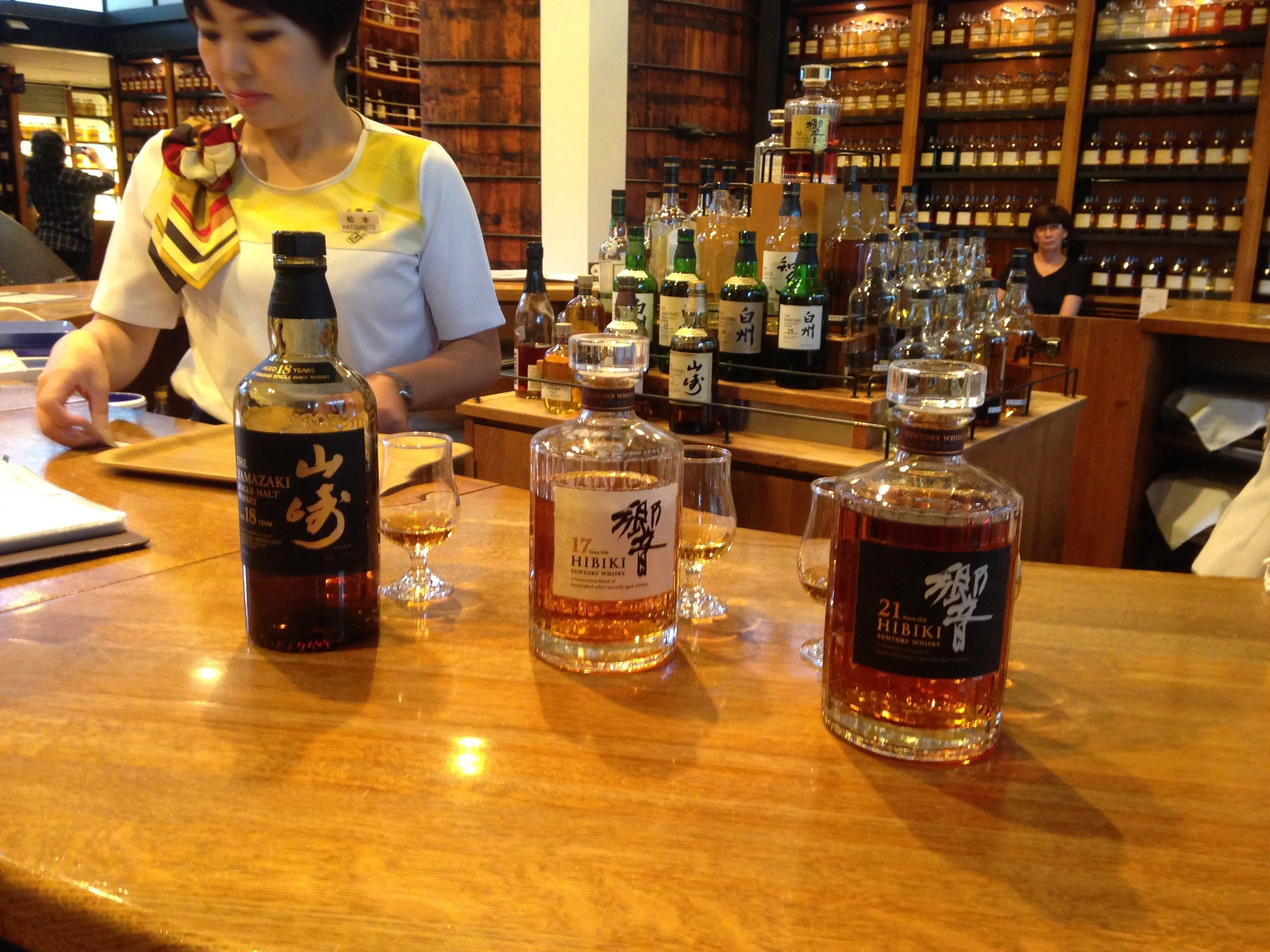 Whiskey tasting counter and server at the whiskey museum. 
