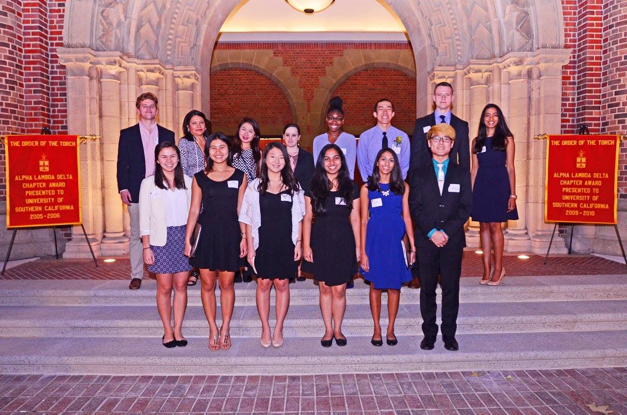 university of southern california members with their order of the torch banners