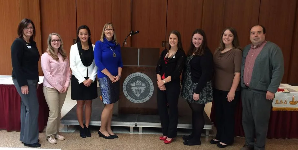 SUNY Fredonia officers and advisors pose with the executive director of alpha lambda delta