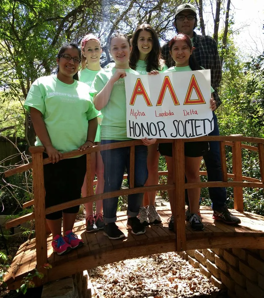 texas state university members representing alpha lambda delta at a community service project