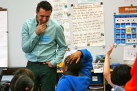 Jarrett Krosoczka engages with a 3rd grader it the Winship School.