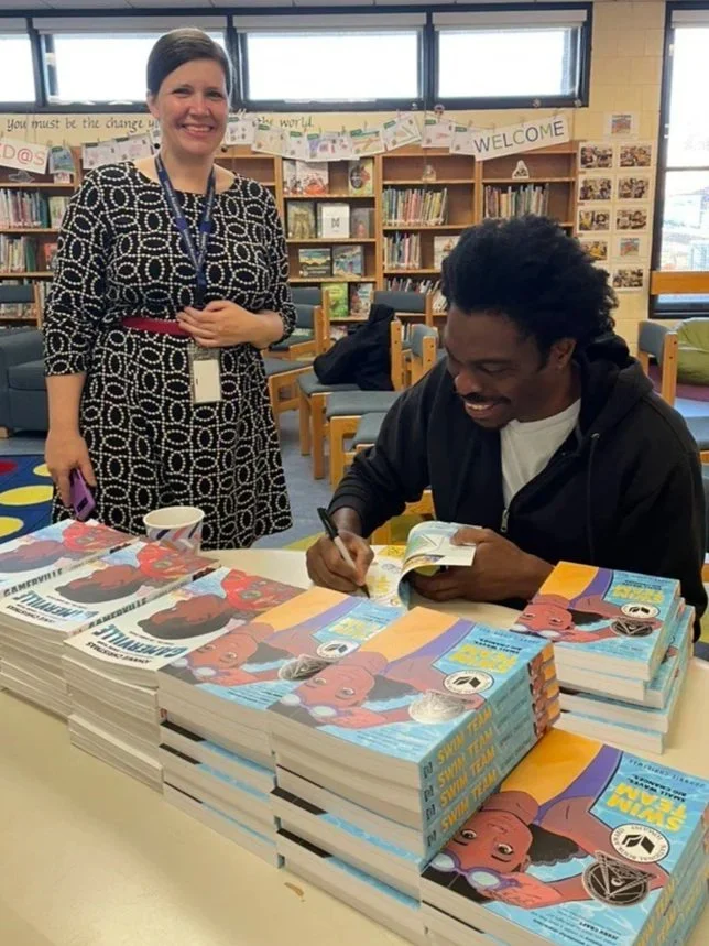 Johnny Christmas signs copies of Gamerville and Swim Team with librarian Hagar Shirman (Copy)
