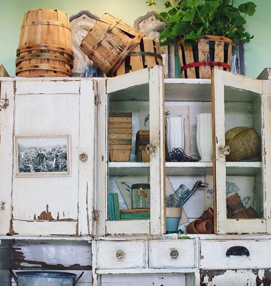 In the potting shed we hung an early 1900s bakers cupboard to hold planting necessities. It's aged patina adds a time-worn feel to the space.