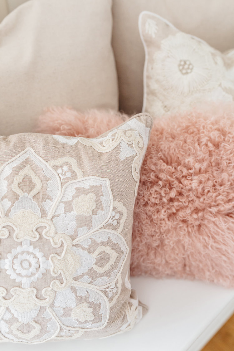 Fun white lacy and pink furry pillows are sprinkled throughout the bridal suite in the McConnell House | Interior design: Kim Leggett, owner of City Farmhouse