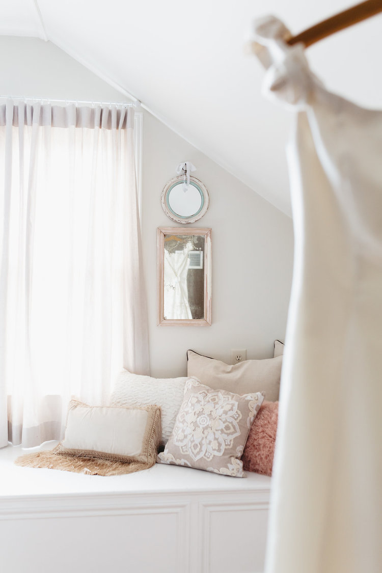 A charming window bench with fun pillows at in the Bridal Suite at the McConnell house | Interior Design: Kim Leggett, owner of City Farmhouse