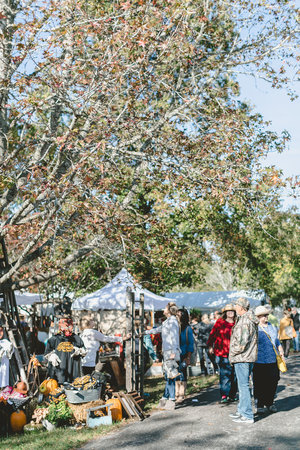 White tents and fall leaves at the City Farmhouse Pop Up Fair