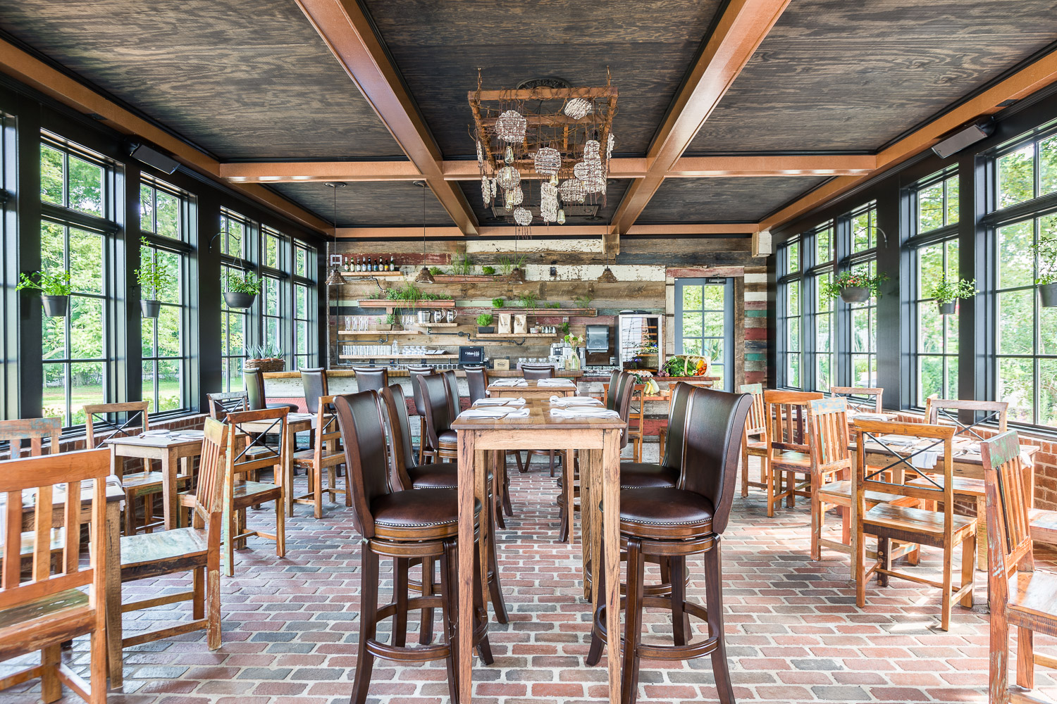 Homestead Manor has a sleek modern bar filled with natural woods and masculine details. | Interior Design: Kim Leggett | Photographer: Alyssa Rosenheck