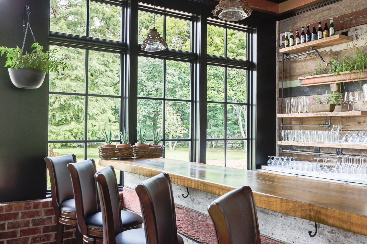 Leather bar stools provide comfortable seat at the bar at Homestead Manor | Interior Design: Kim Leggett | Photographer: Alyssa Rosenheck