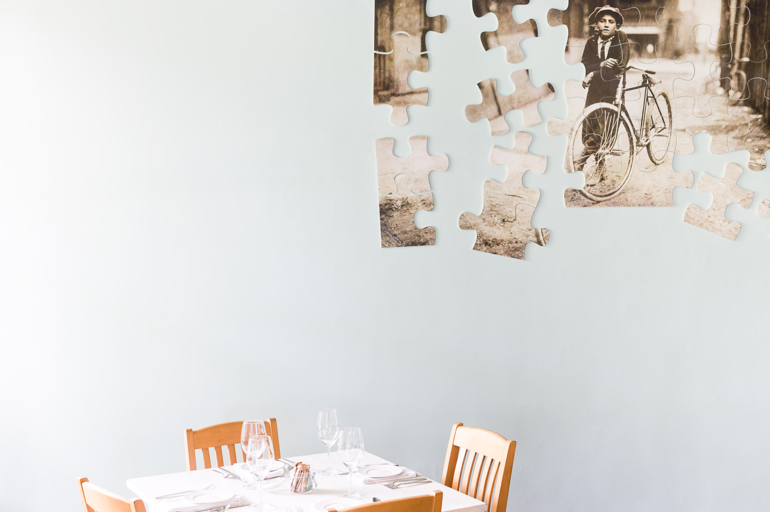 A puzzle with pieces scaling the wall at Homestead Manor | Interior Design: Kim Leggett | Photographer: Alyssa Rosenheck