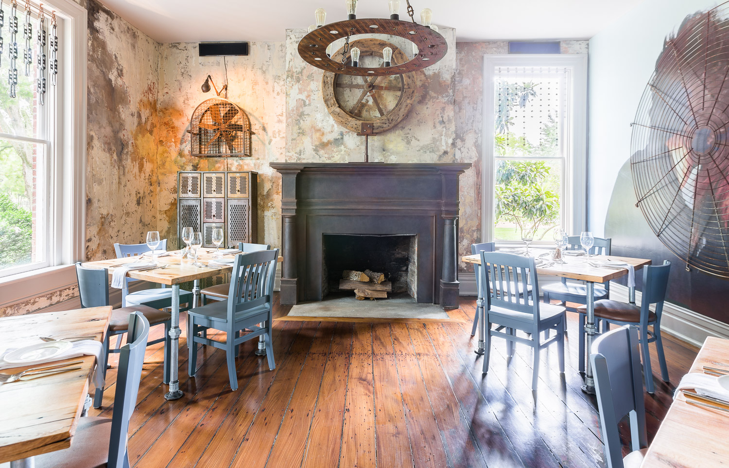 A rustic dining area with blue chairs at Homestead Manor | Interior Design: Kim Leggett | Photographer: Alyssa Rosenheck