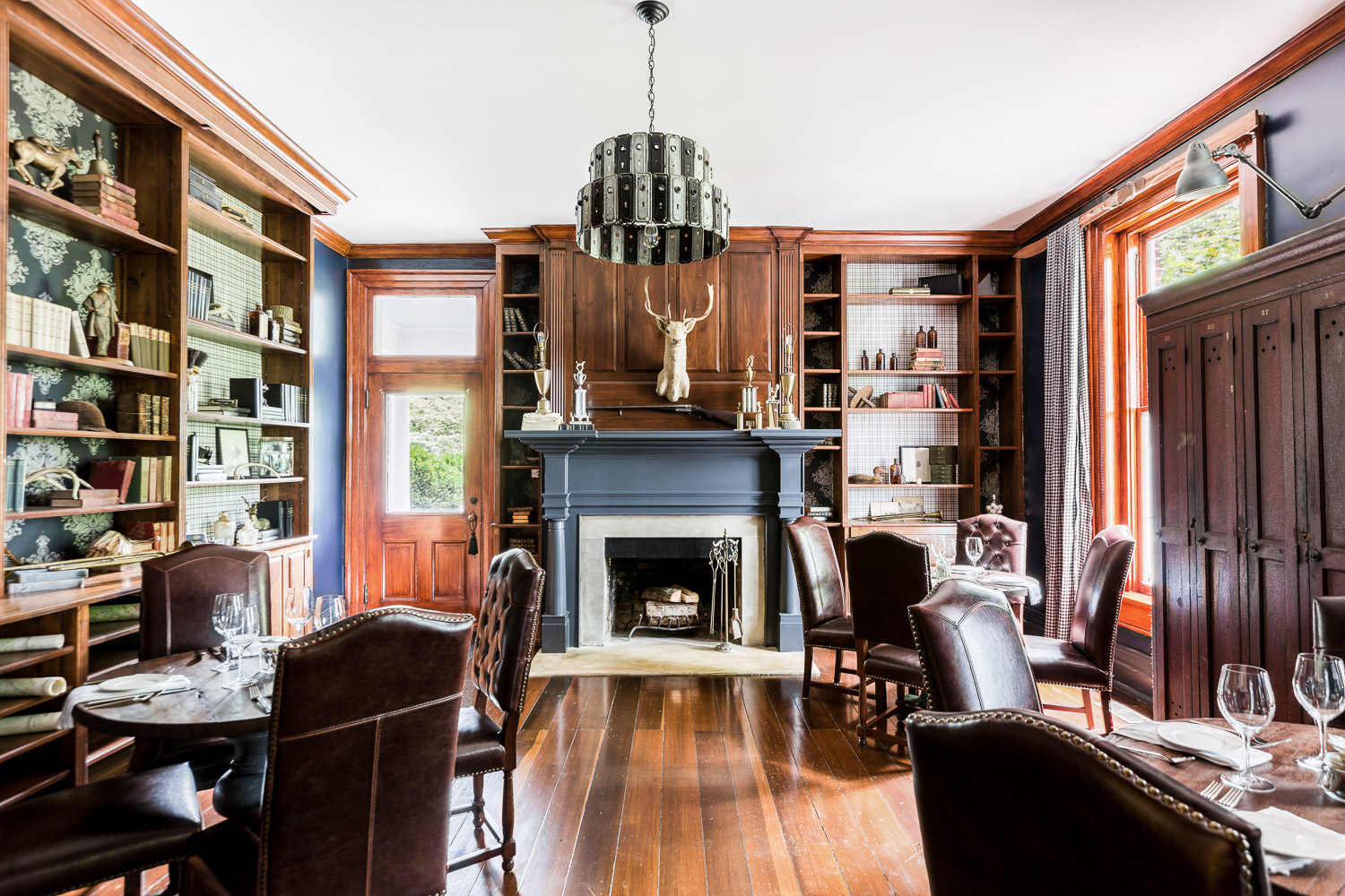 This cozy room has a library type feel with antique books and dark wood throughout | Interior Design: Kim Leggett | Photographer: Alyssa Rosenheck