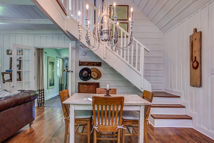 Beautiful farmhouse white staircase at The Nest in Leiper's Fork | Interior Designer: Kim Leggett