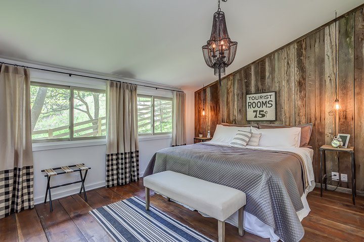 Wood planks installed vertically add a rustic charm to the wall at the Nest | Interior Designer: Kim Leggett